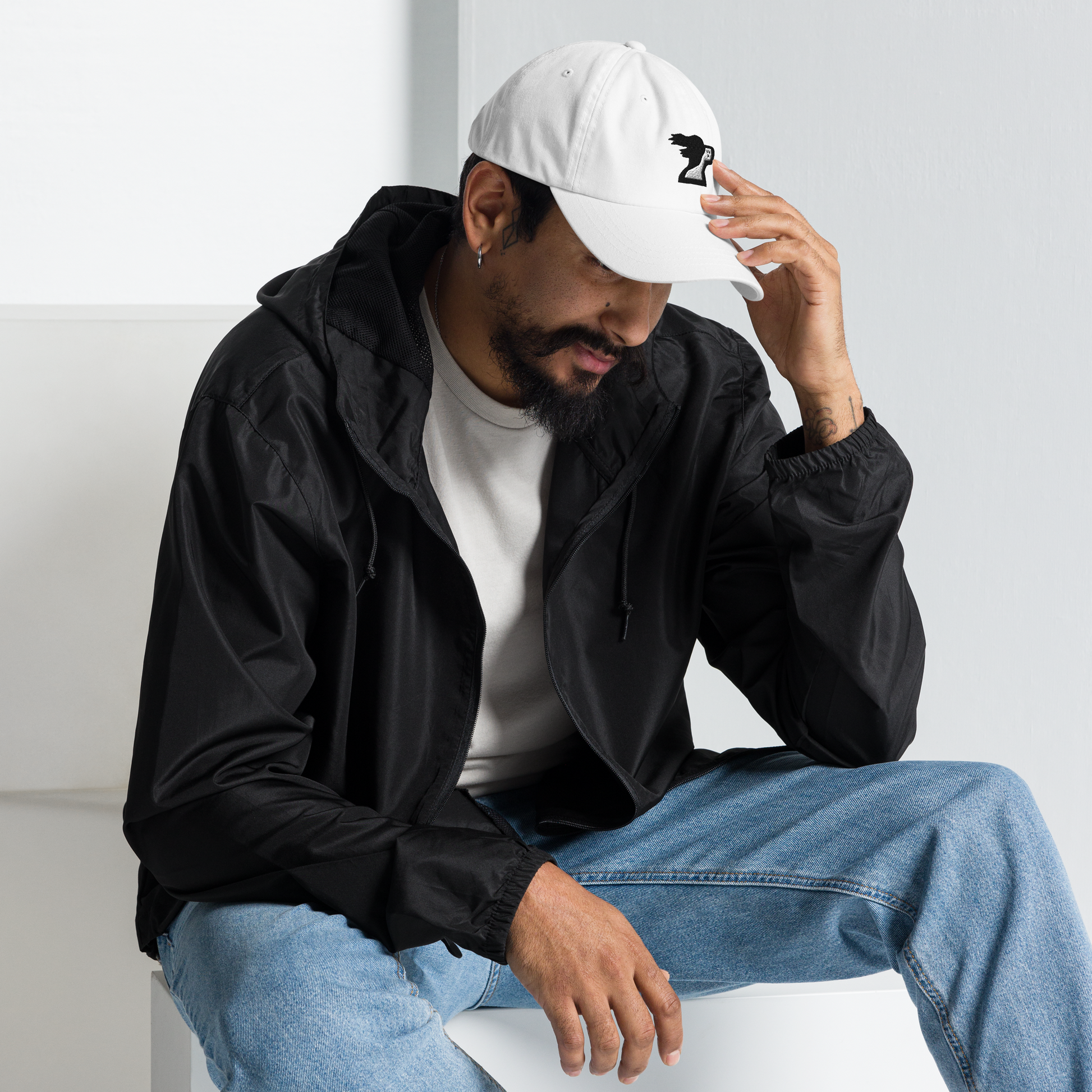 Man wearing white dad hat with brand logo by the Harbor Springer brand.