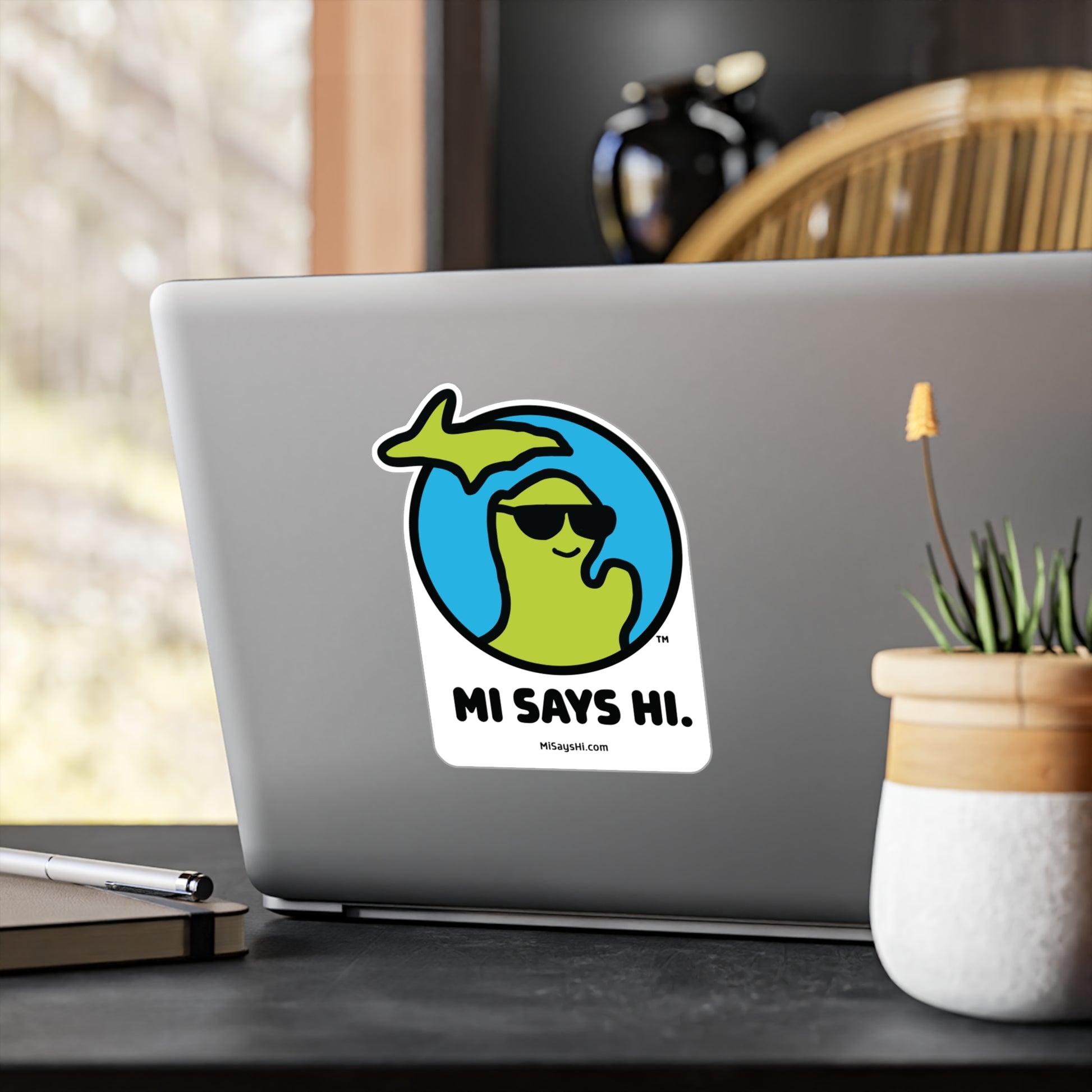 Large vinyl laptop sticker with waving Michigan logo wearing sunglasses.