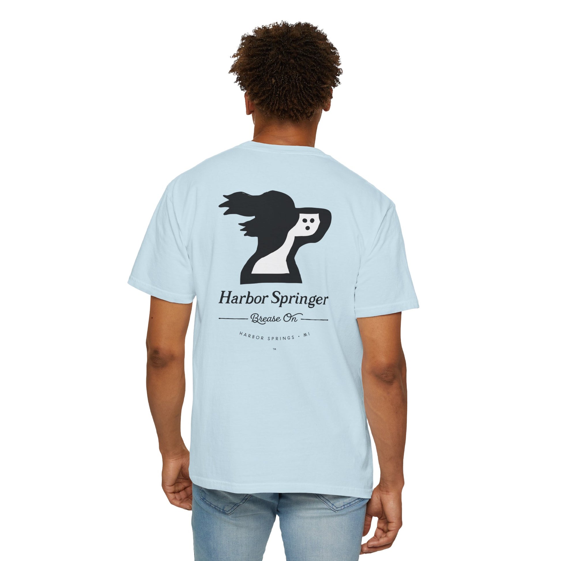 Man wearing light blue t-shirt by the Harbor Springer brand with a springer spaniel dog logo and Brease On tagline on the back.