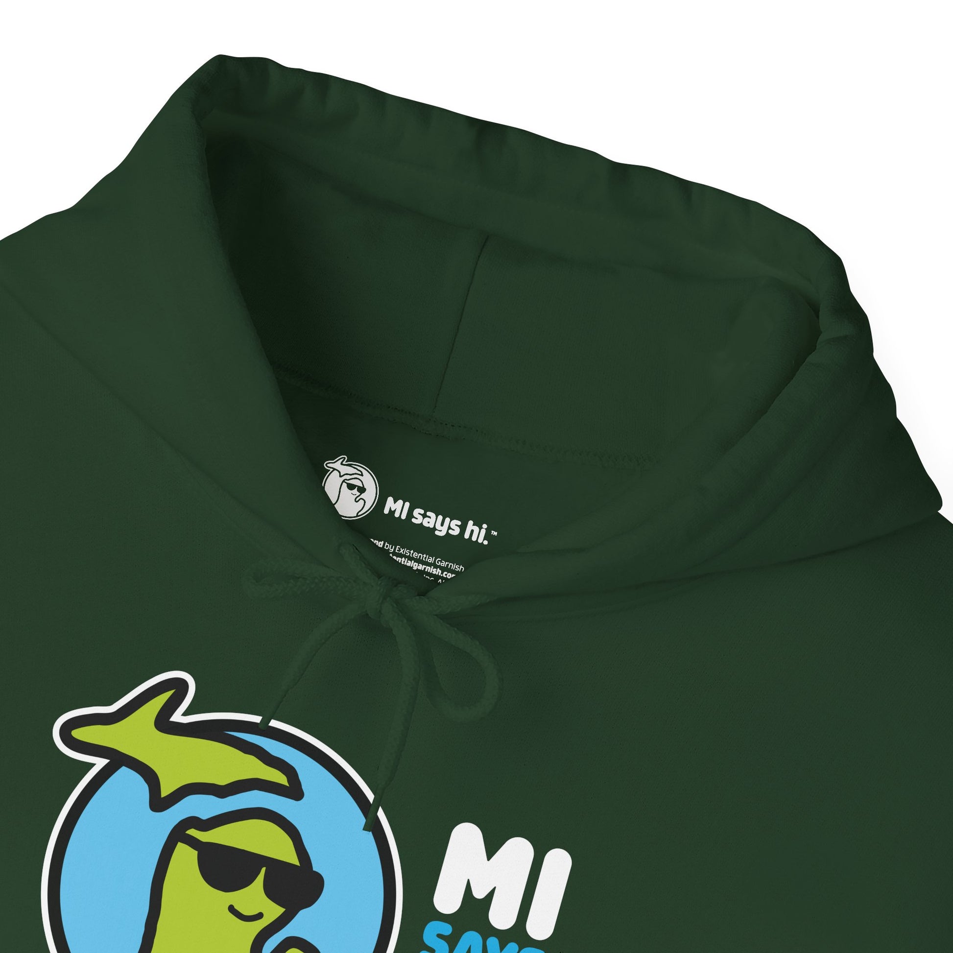 Closeup of neck label of a green hoodie with waving Michigan logo wearing sunglasses and smiling for the MI Says Hi brand.