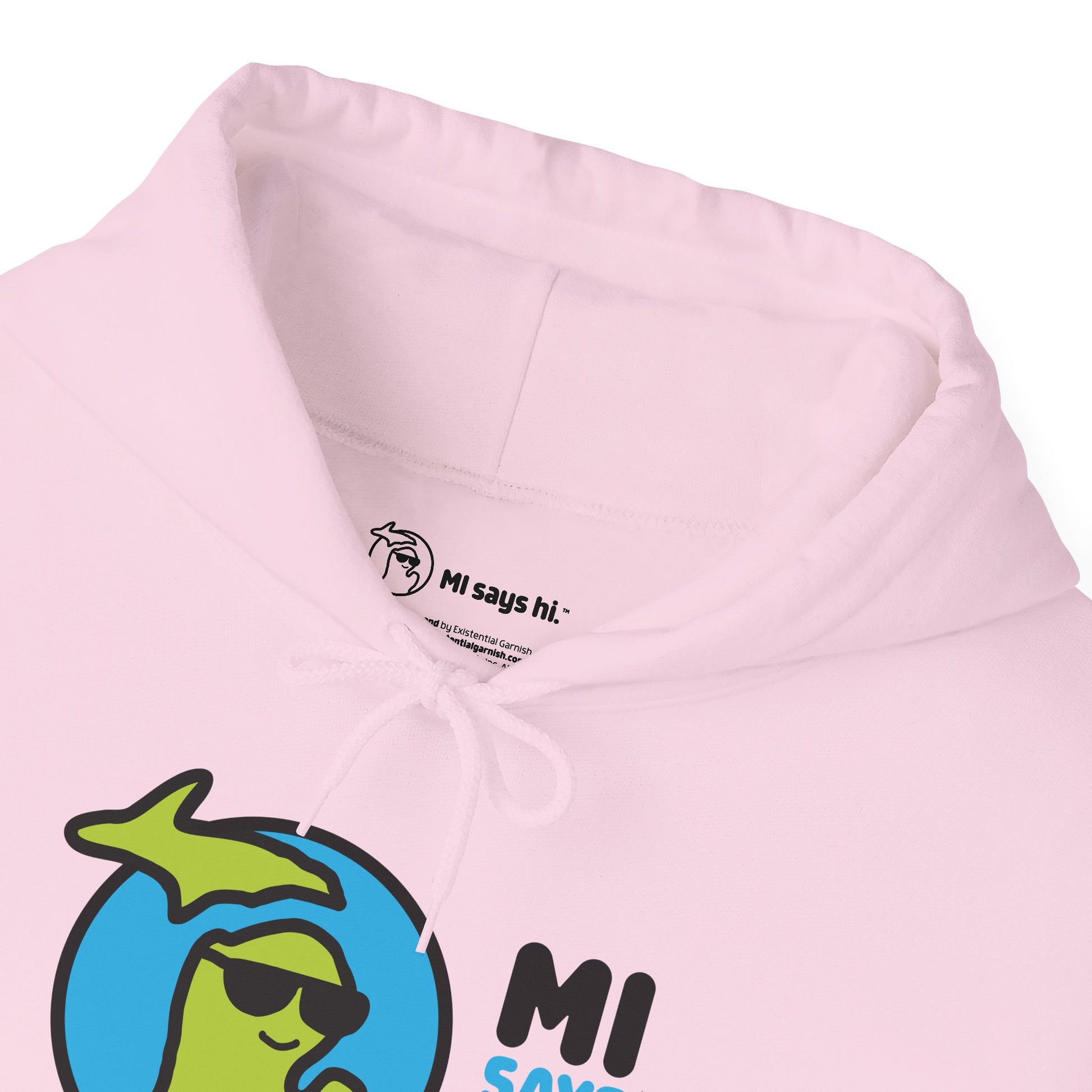 Closeup of neck label of a pink hoodie with waving Michigan logo wearing sunglasses and smiling for the MI Says Hi brand.