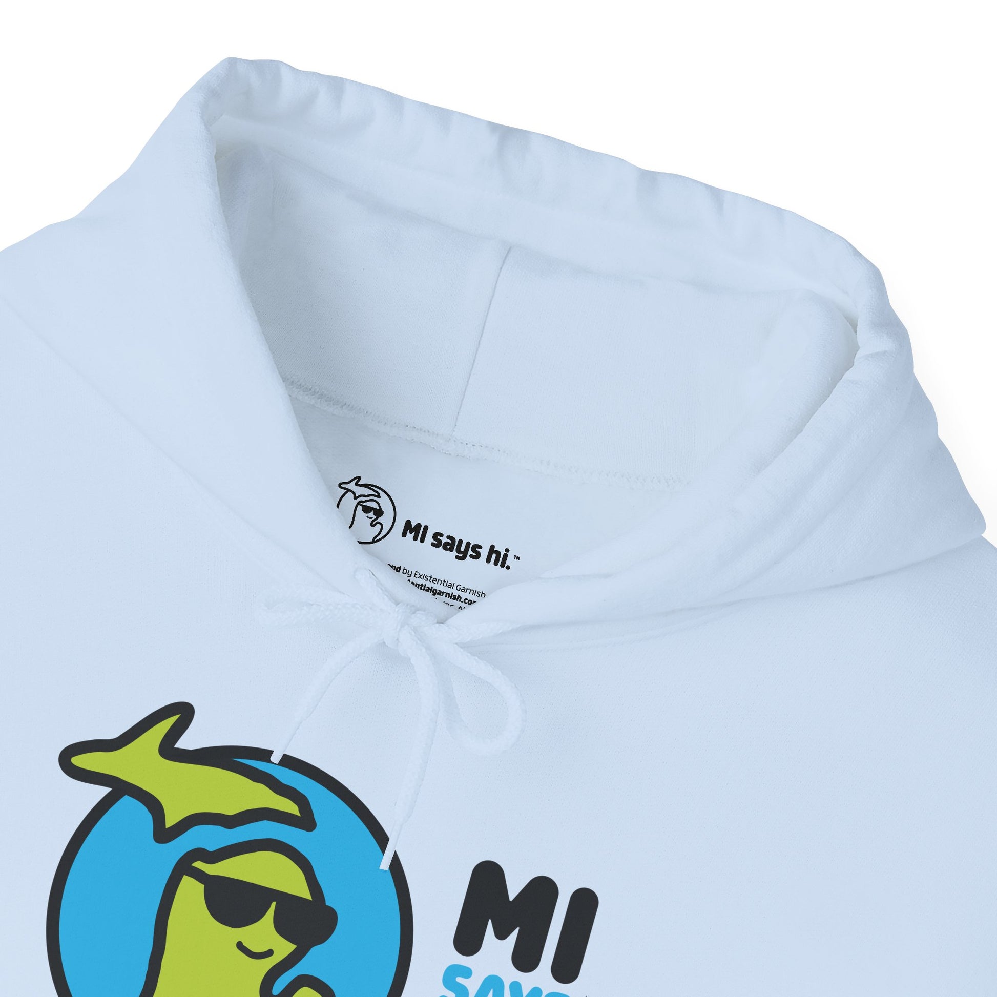 Closeup of neck label of a light blue hoodie with waving Michigan logo wearing sunglasses and smiling for the MI Says Hi brand.