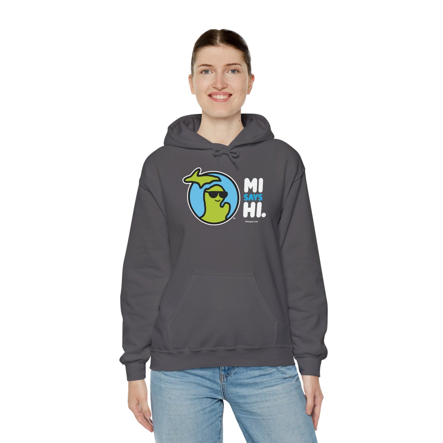 Woman wearing a gray hoodie with waving Michigan logo wearing sunglasses and smiling for the MI Says Hi brand.